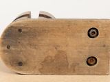 a wooden block with a metal handle on a table