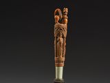an image of a wooden stick with carvings on it