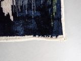 a black and white picture of a cat on a blue and white rug