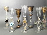 many different types of glass goblets on a table