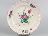 a white plate with pink flowers painted on it