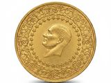 gros plan d'une pièce d'or sur laquelle figure le visage d'un homme