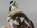 a close up of a vase with a hat on it