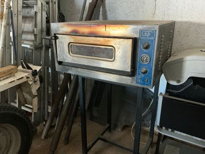 an image of a commercial pizza oven in a garage