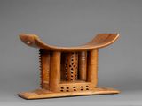 an image of a wooden stool with a carved design on top of it