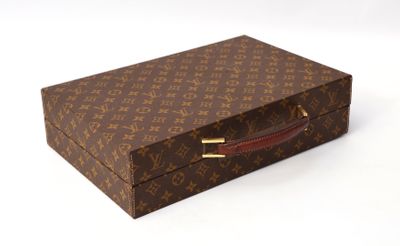 a brown and brown louis vuitton suitcase on a white surface