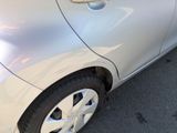 a silver car parked in a parking lot next to a parking meter
