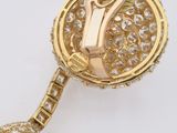 a close up of a gold and diamond broochle