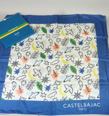 a blue book and a white scarf on a table