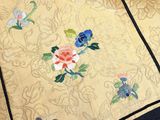 a close up of a jacket with flowers on it