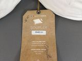 a tag that says souplex on it next to a pair of pillows