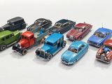 several toy cars are lined up in a row on a white surface