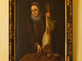 un tableau représentant une femme tenant un canard, accroché au mur