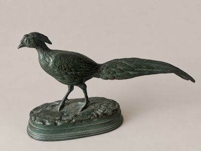statue of a pheasant on a base on a white background