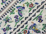 an image of a close up of a table cloth with flowers and butterflies on it