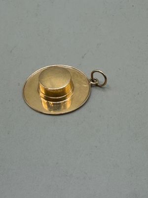 a gold coin on a silver plate on a white surface