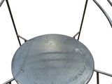 a metal chair that has a metal seat on it