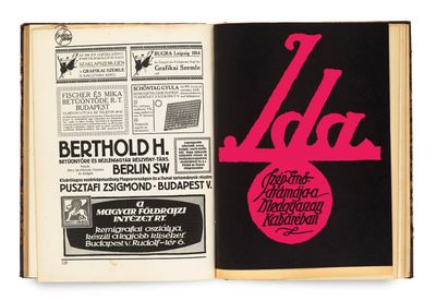 an open book with a black cover and a pink logo on it