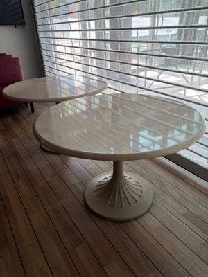 two tables that are sitting in front of a window