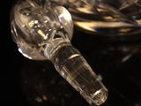 close up of a crystal wine decanter on a black surface