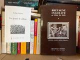 many books that are on a shelf in the room