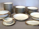 a lot of plates and bowls that are on the table