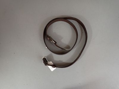 a brown leather strap with a silver clasp on it