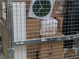 a metal cage with a clock on top of it