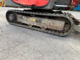 a red and black bulldozer sitting on the ground