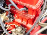 a close up view of a red engine with wires