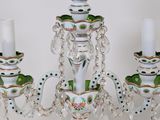 a chandelier that has a green and white design on it