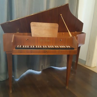 a piano that is sitting on a wooden table
