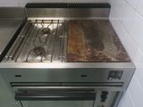 a stove that has a burner on it in a kitchen