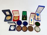 a lot of medals and other items on the table