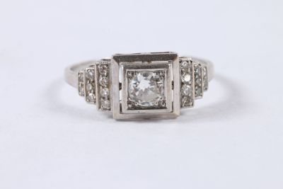 a close up of a ring with a diamond in the center