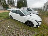 the white car is parked on the side of the road in the grass