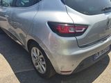 the rear end of a silver car parked in a parking lot