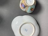 two cups and a saucer sitting on a table