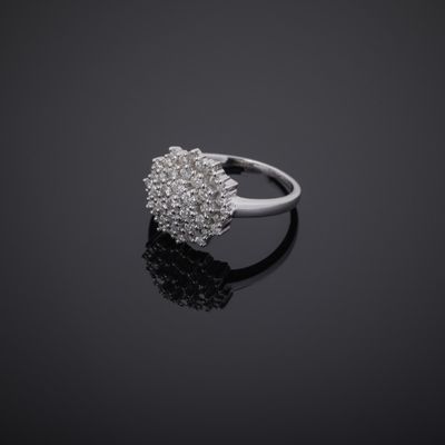 a close up of a diamond ring on a black surface