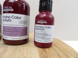 two bottles of hair color sitting on a wooden cutting board