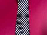 a close up of a tie on a pink background