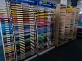 a lot of different colors of paper on the shelves in the store