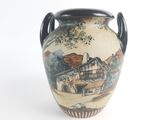 a vase with a picture of a house on it