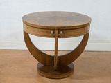 a small wooden table with a circular top