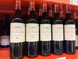 many bottles of wine sitting on a shelf in a store