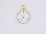 a gold pocket watch with a white face on a white surface