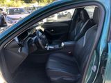 the interior of a green car with black leather seats and a steering wheel