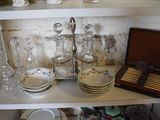 a shelf that has a lot of dishes and cups on it