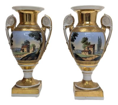 pair of antique vases with a painting of a landscape on them