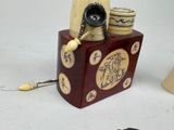 a small wooden box with a pipe on top of it